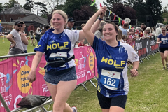 2-women-celebrating-coming-over-the-finishing-line