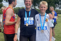 mum and son wearing their 5K medals